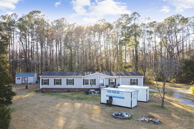 manufactured / mobile home with an outbuilding, crawl space, and a shed