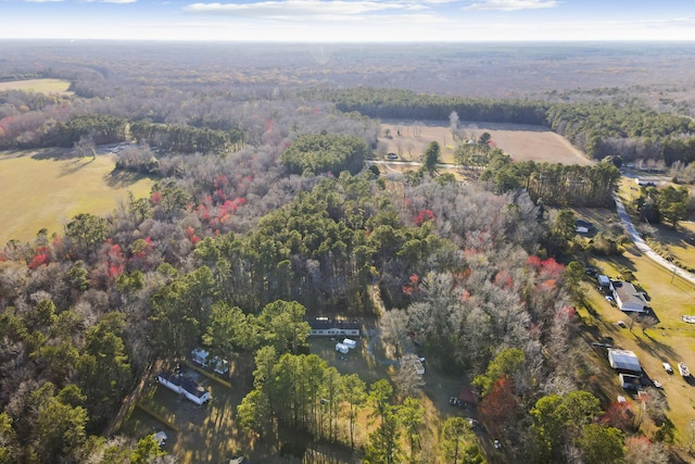 bird's eye view with a wooded view