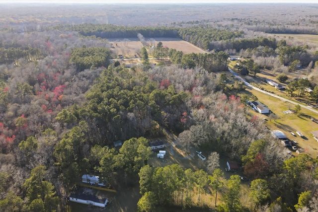 birds eye view of property featuring a view of trees