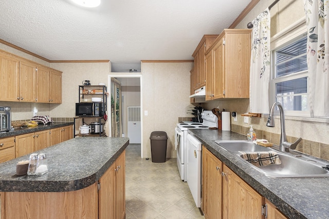 kitchen with white appliances, ornamental molding, under cabinet range hood, a sink, and dark countertops