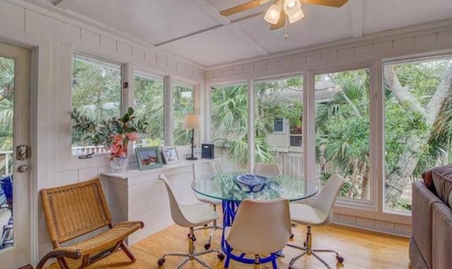 sunroom / solarium with a wealth of natural light, ceiling fan, and coffered ceiling