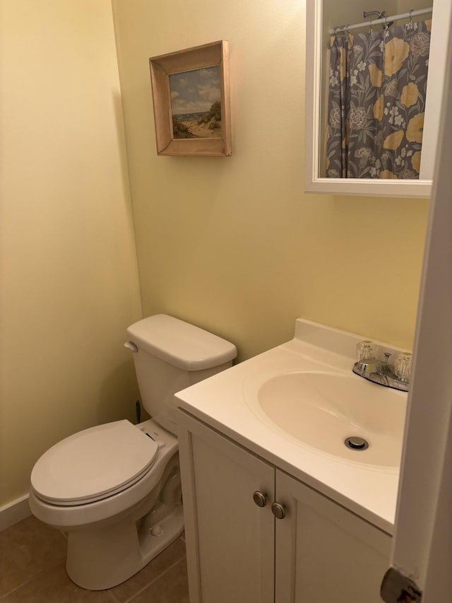 bathroom featuring tile patterned flooring, vanity, and toilet