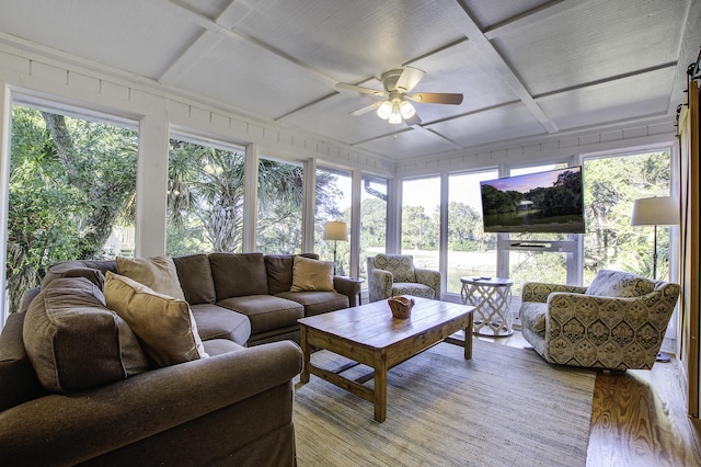 sunroom / solarium with ceiling fan and coffered ceiling