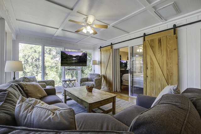 living room with wood-type flooring, a barn door, ceiling fan, and coffered ceiling