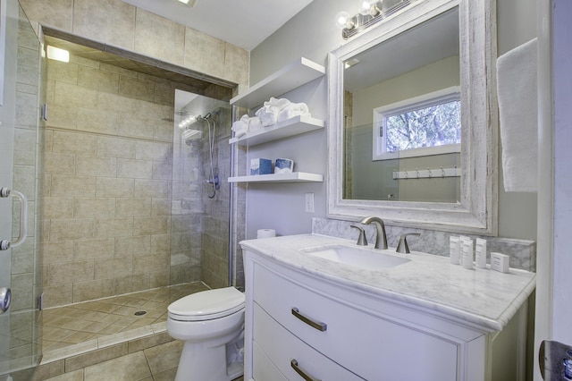 bathroom with tile patterned flooring, vanity, toilet, and an enclosed shower