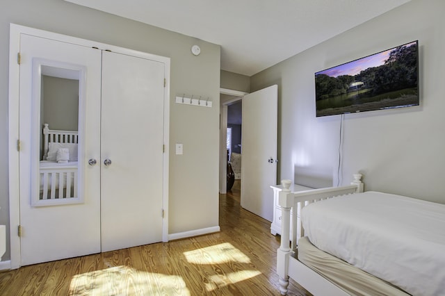 bedroom featuring light wood-type flooring and a closet