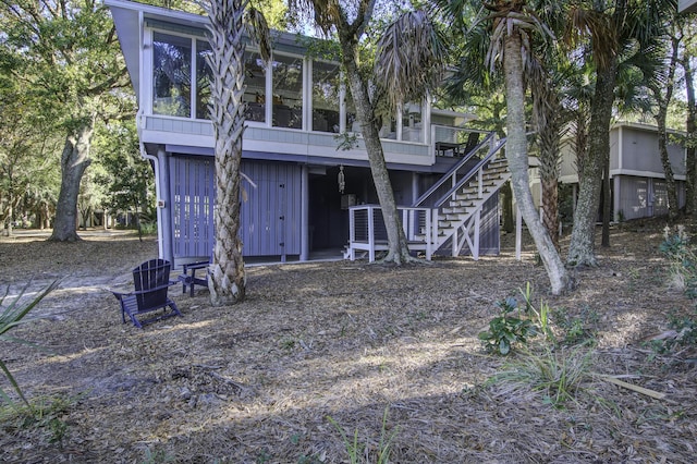 rear view of property with a sunroom