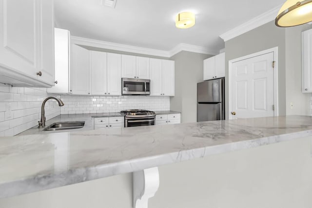 kitchen featuring white cabinetry, sink, stainless steel appliances, and light stone countertops