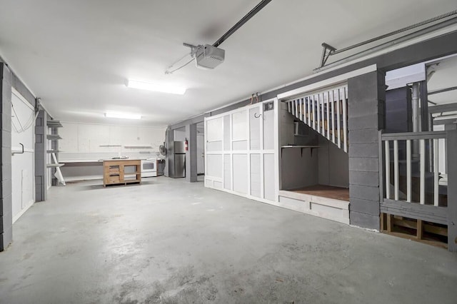 garage featuring a garage door opener and stainless steel refrigerator