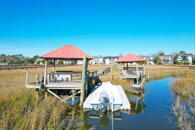 view of dock featuring a gazebo and a water view