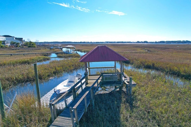 view of dock with a water view and a rural view