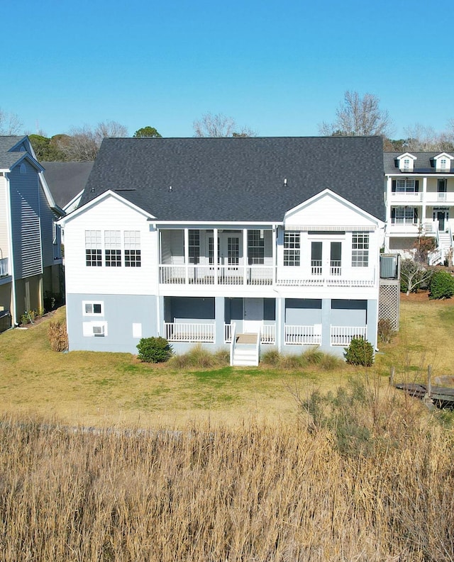 back of house featuring a lawn