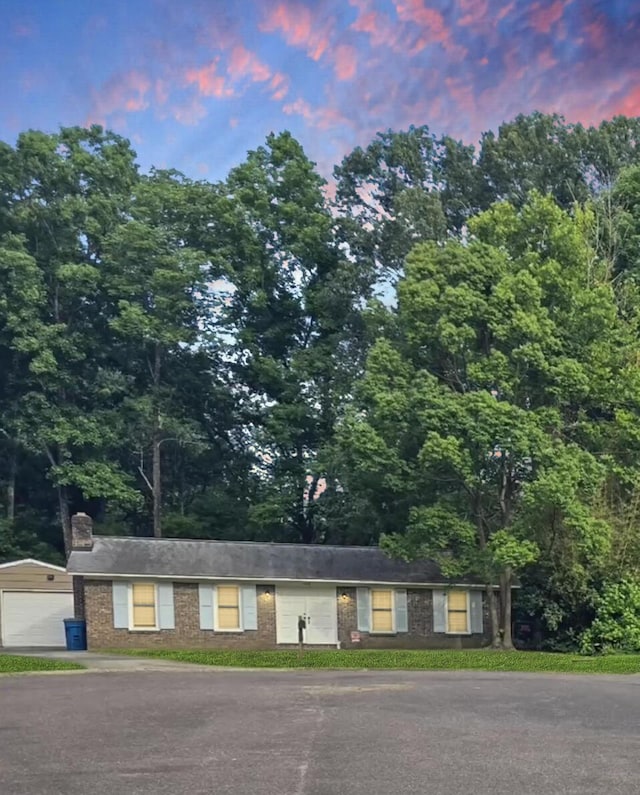 ranch-style home with a detached garage