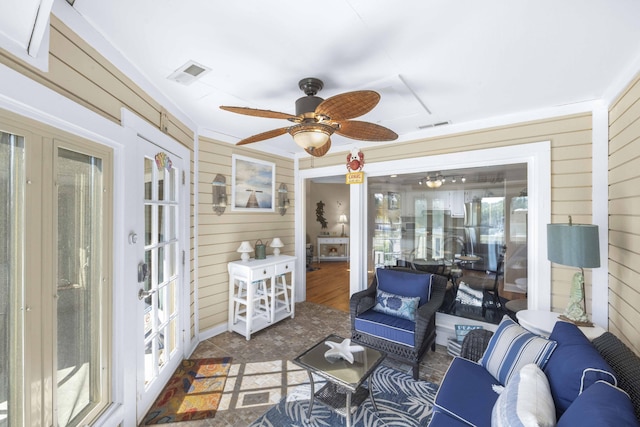 sunroom featuring visible vents, a ceiling fan, and french doors