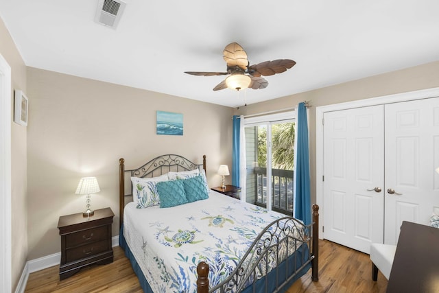 bedroom featuring visible vents, wood finished floors, a closet, and access to exterior