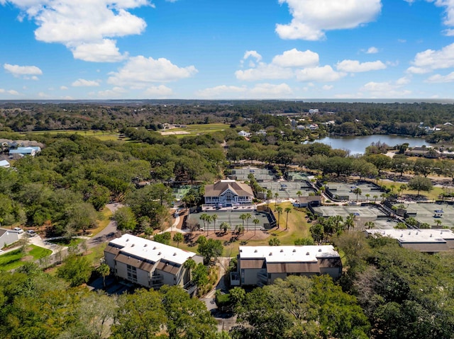 drone / aerial view featuring a forest view and a water view