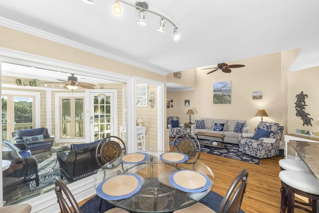 dining area featuring ornamental molding, wood finished floors, and ceiling fan