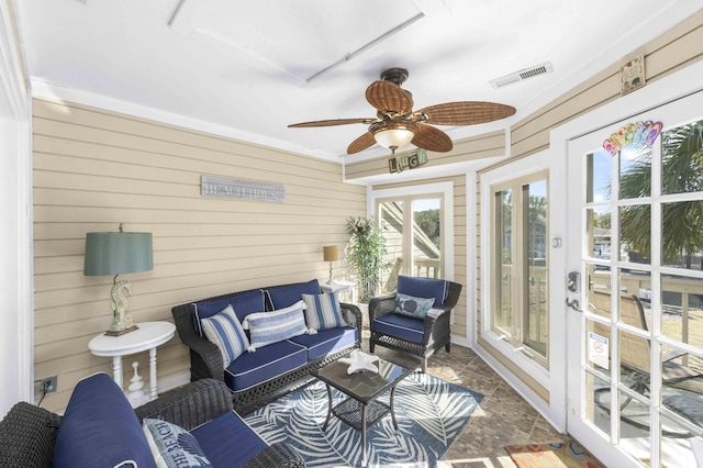 sunroom / solarium with visible vents and a ceiling fan