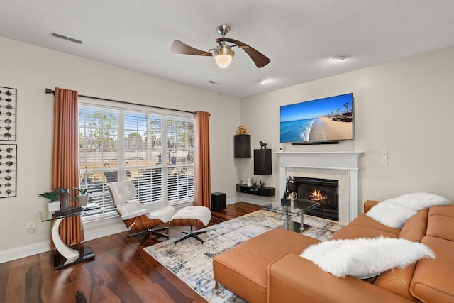 living room featuring a textured ceiling, ceiling fan, and hardwood / wood-style floors