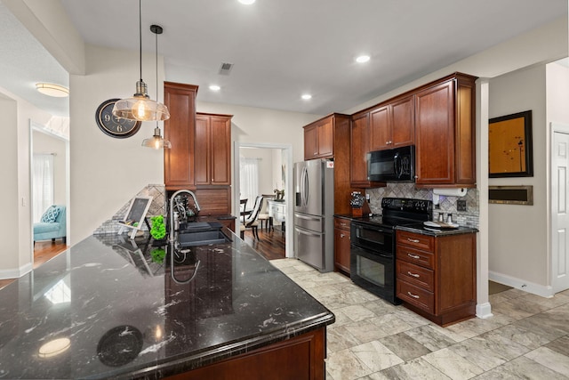 kitchen with dark stone countertops, black appliances, decorative backsplash, sink, and decorative light fixtures