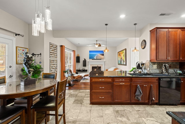 kitchen with sink, decorative backsplash, hanging light fixtures, and black dishwasher