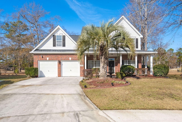 view of front of home featuring a front yard, a garage, and covered porch