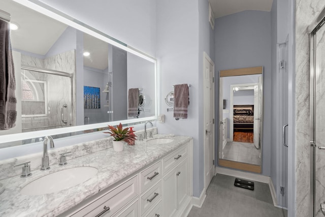 bathroom with lofted ceiling, a shower with door, tile patterned floors, and vanity