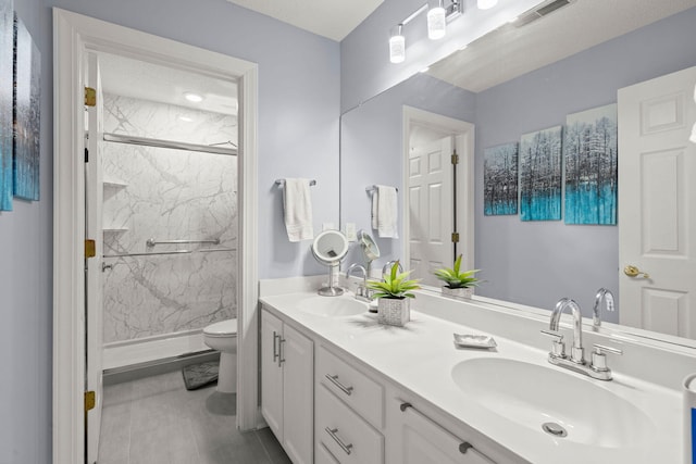 bathroom with a shower with door, vanity, and toilet