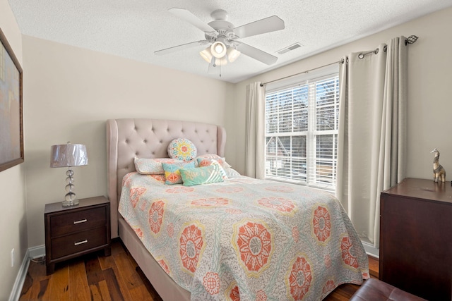 bedroom featuring a textured ceiling, ceiling fan, and dark hardwood / wood-style flooring