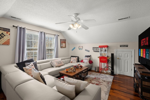 living room featuring a textured ceiling, ceiling fan, vaulted ceiling, and dark hardwood / wood-style floors