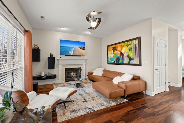 living room with ceiling fan and dark wood-type flooring