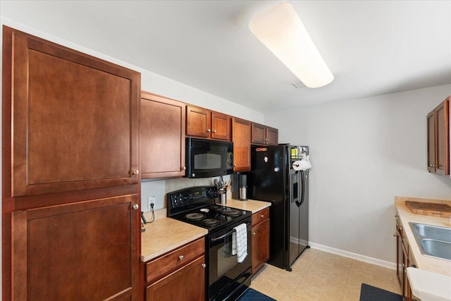 1170 Deerberry Rd, Hanahan, SC 29410 - kitchen featuring black appliances, baseboards, light countertops, and a sink