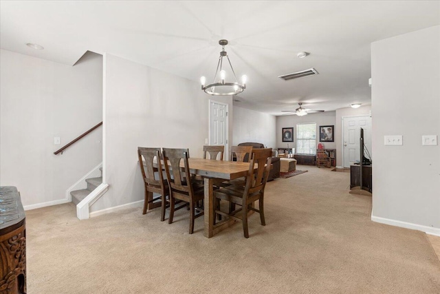 1170 Deerberry Rd, Hanahan, SC 29410 - dining room with light colored carpet, stairs, a chandelier, and a ceiling fan