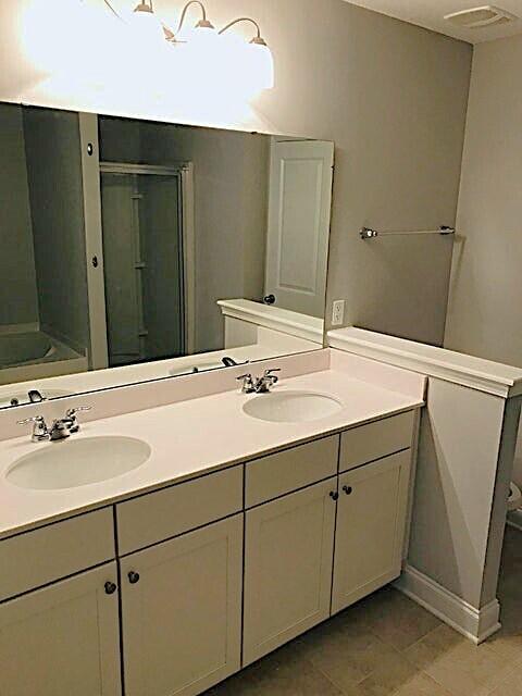 bathroom with vanity, independent shower and bath, and tile patterned flooring