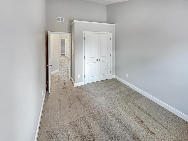 unfurnished bedroom featuring a closet and carpet flooring