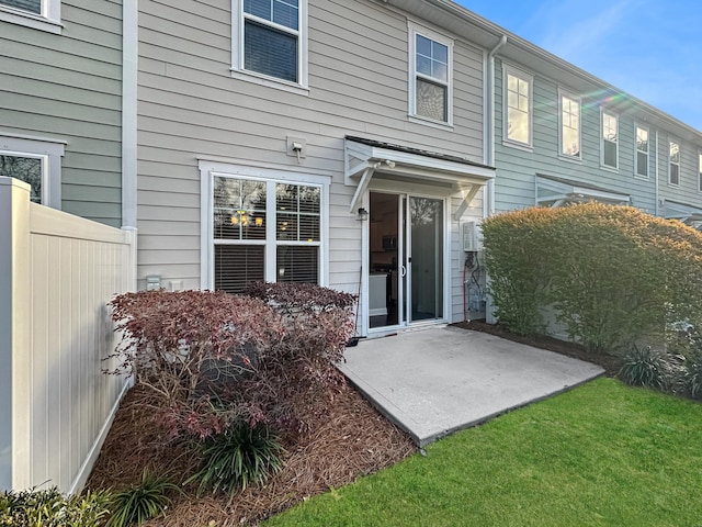 rear view of property with a patio area and a lawn