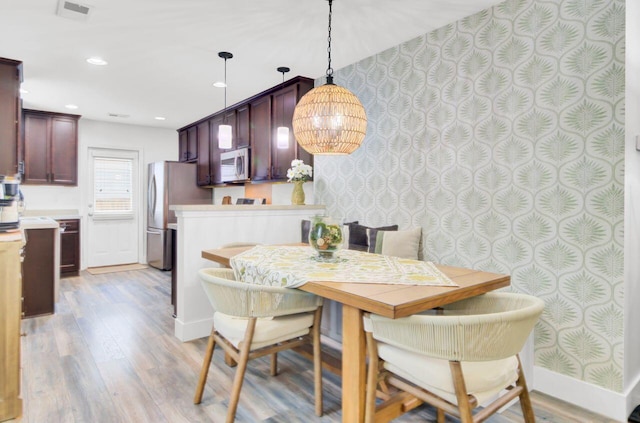 100 Runnels Cv, Summerville, SC 29485 - dining area with light wood-type flooring, a chandelier, baseboards, wallpapered walls, and recessed lighting