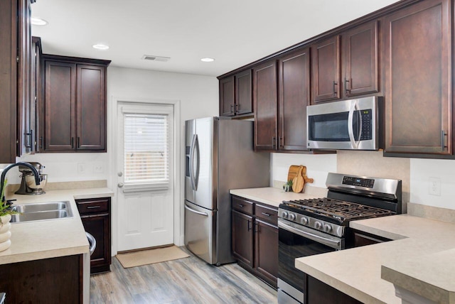 100 Runnels Cv, Summerville, SC 29485 - kitchen featuring stainless steel appliances, a sink, light countertops, light wood-type flooring, and recessed lighting