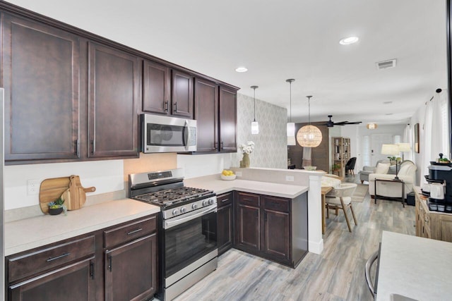 100 Runnels Cv, Summerville, SC 29485 - kitchen featuring stainless steel appliances, light wood-style flooring, light countertops, a peninsula, and a ceiling fan