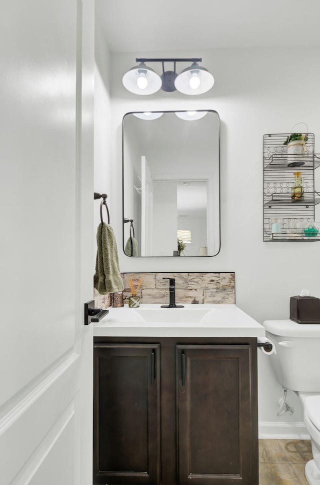 100 Runnels Cv, Summerville, SC 29485 - bathroom featuring toilet, vanity, and tasteful backsplash