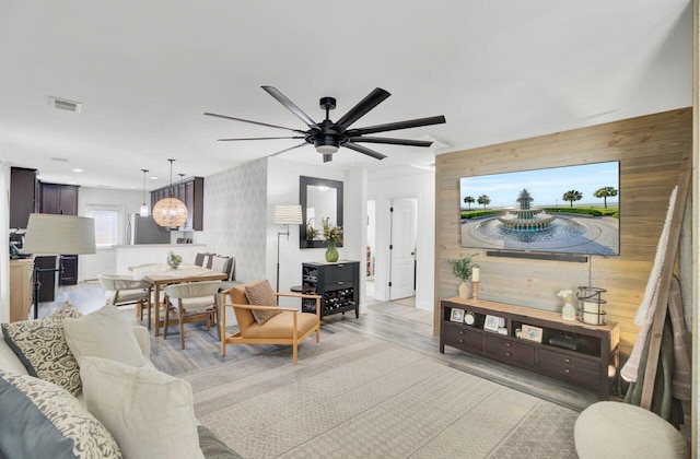 100 Runnels Cv, Summerville, SC 29485 - living room featuring wooden walls, wood finished floors, and a ceiling fan
