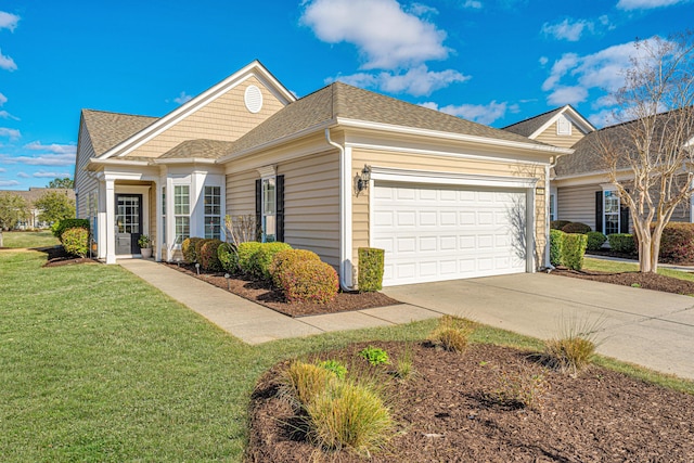 view of front facade featuring a garage, concrete driveway, a front lawn, and a shingled roof