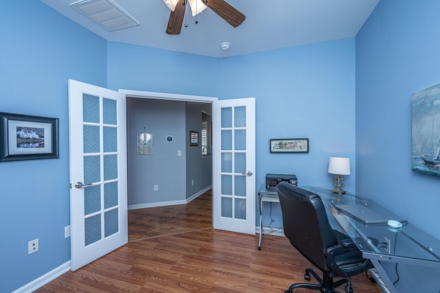 office space with visible vents, baseboards, french doors, wood finished floors, and a ceiling fan