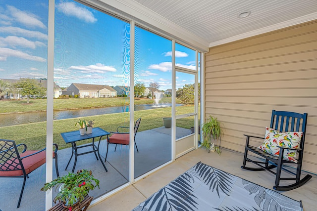 sunroom / solarium with a water view