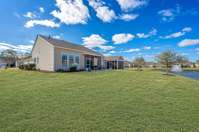 back of house featuring a lawn and a sunroom