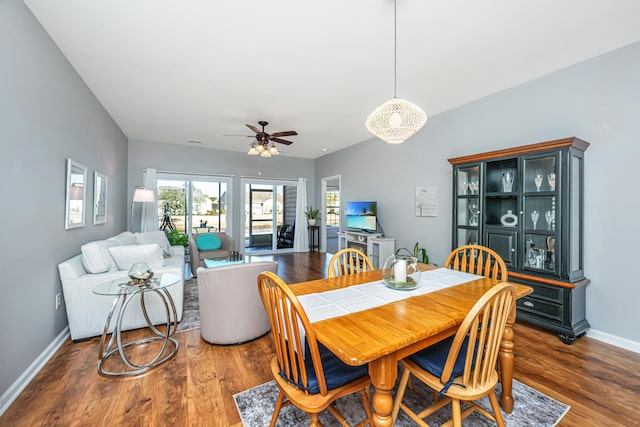 dining room featuring wood finished floors, baseboards, and ceiling fan