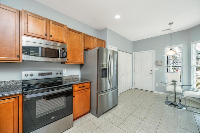 kitchen featuring hanging light fixtures, visible vents, appliances with stainless steel finishes, and brown cabinets