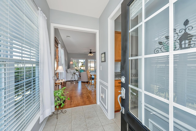 interior space featuring light tile patterned flooring and a ceiling fan