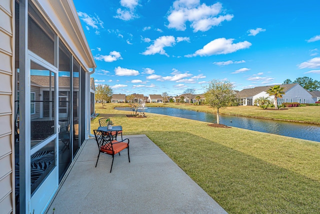 view of patio featuring a water view and a residential view