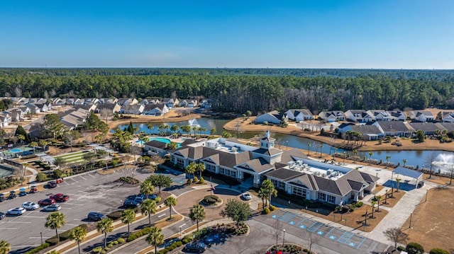 aerial view featuring a residential view, a view of trees, and a water view